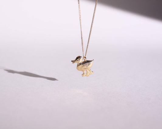pendentif en laiton plaqué or symbolisant un canard disposant de trois pattes