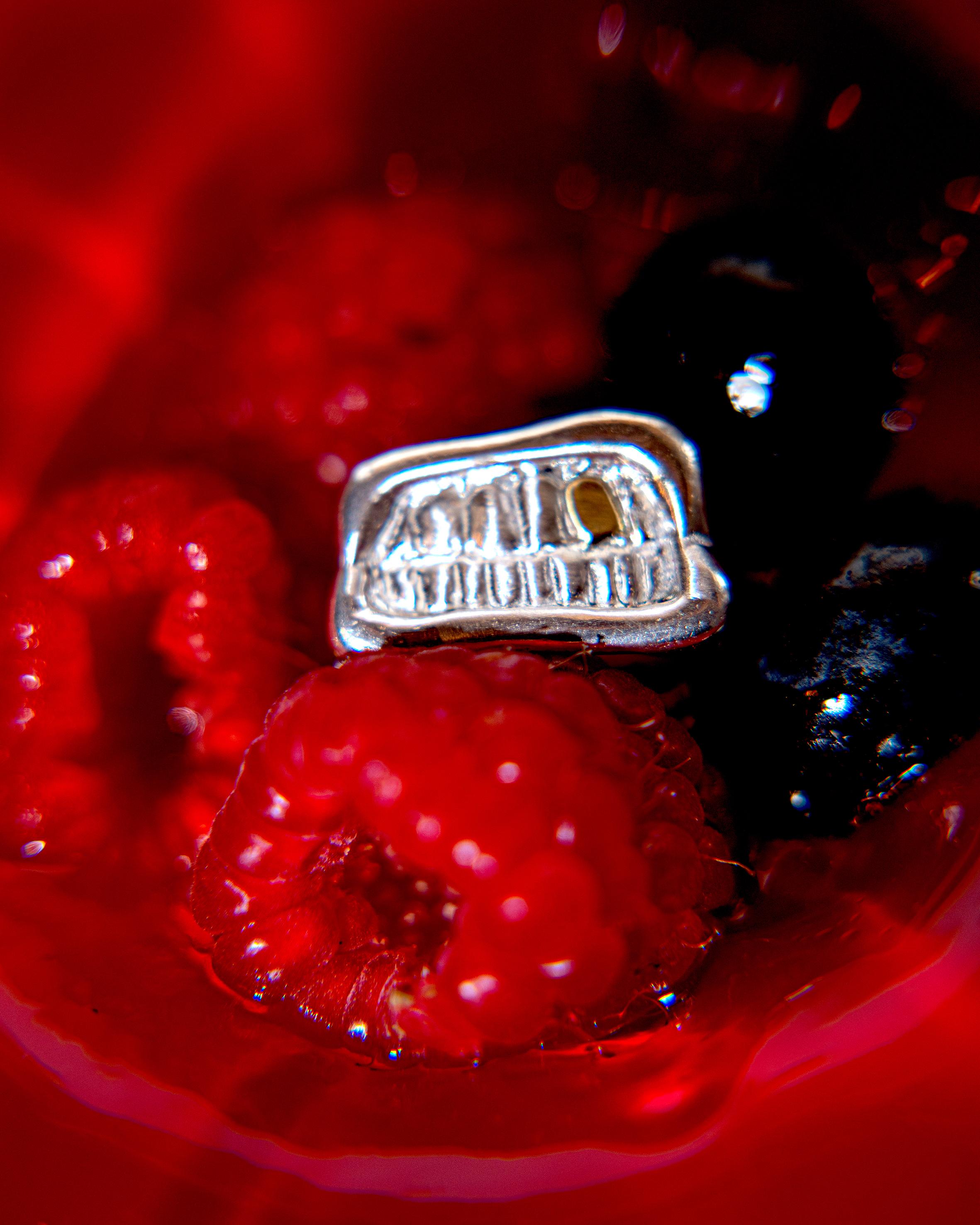 bague sourire d'enfer posée dans des framboises