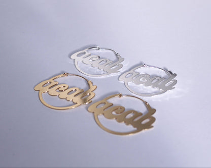 ensemble de boucles d'oreilles portant l'acronyme "ACAB"