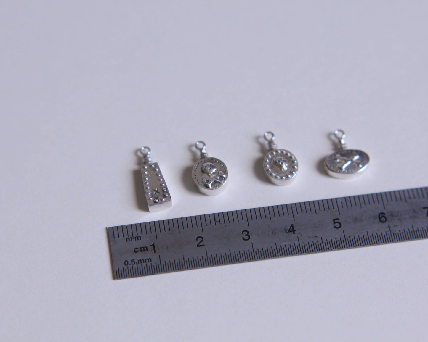 série de pendentifs en argent représentant des fioles de poison