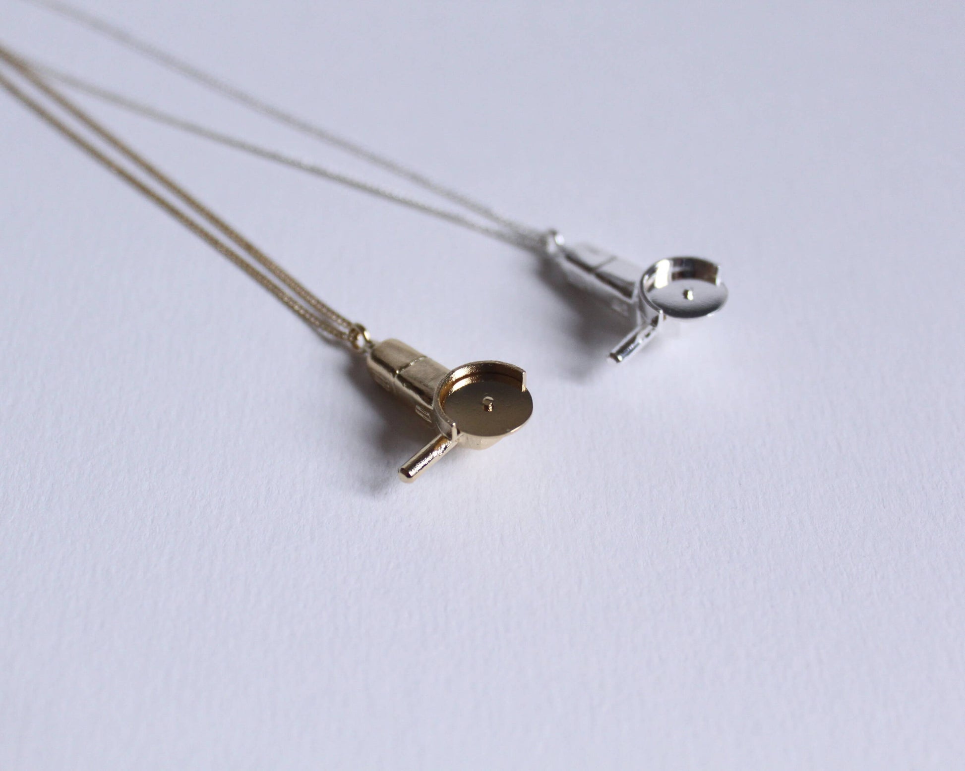 collier avec pendentifs en argent massif et en laiton plaqué or symbolisant des meuleuses